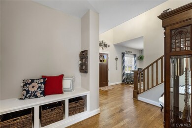 Mudroom with hardwood floors, drop zone next to ga