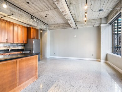 Kitchen featuring light speckled floor, a sink, d