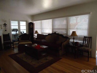 LIVING ROOM HAS AMPLE LIGHT AND FRENCH DOORS INTO 