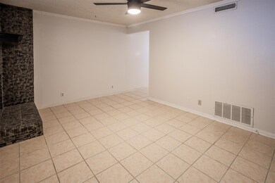 Spare room with a textured ceiling, light tile pa