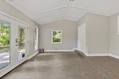 Unfurnished sunroom with vaulted ceiling