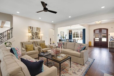 Living room with arched walkways, hardwood / wood-
