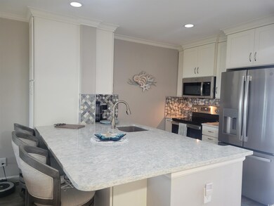 Kitchen with kitchen peninsula, appliances with st