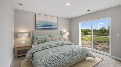 The spacious primary bedroom is large enough for a king a full bedroom set! Photo is of a model home, finishes and colors may vary.