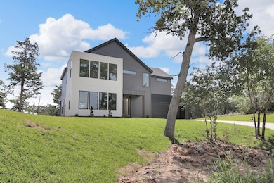 Back of property featuring a lawn and an attached