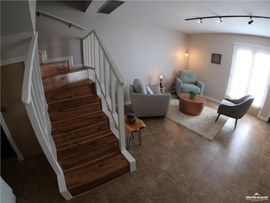 Stairs with rail lighting and tile patterned flooring