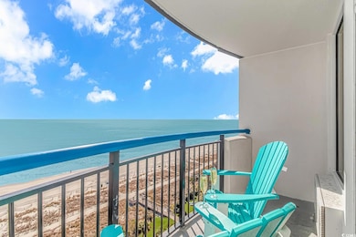 Balcony with a water view and a view of the beach
