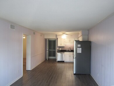 Kitchen featuring sink, white cabinetry, appliance