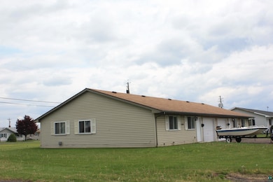 Rear view of property featuring a lawn and an attached garage