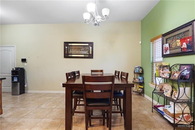 Dining space with a chandelier and light tile patterned floors