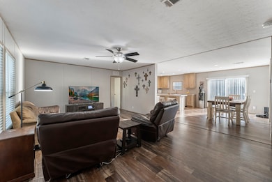 As you step through the front door, you're greeted by an inviting, open-concept space where the cozy living room seamlessly flows into the modern kitchen