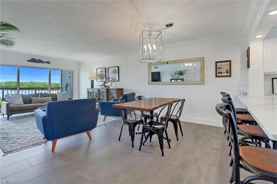 Dining room featuring ornamental molding, light ti