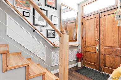 Foyer with stairway and wood finished floors