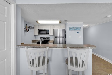 Kitchen with a breakfast bar area, a textured ceil