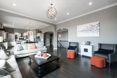 Custom lighting, crown molding, arched doorways and hardwood floors!  Beautiful!