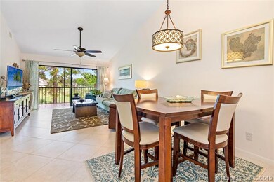 Open concept dining area and living room with tile