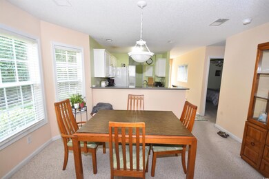 Dining area with sink, a textured ceiling, plenty 