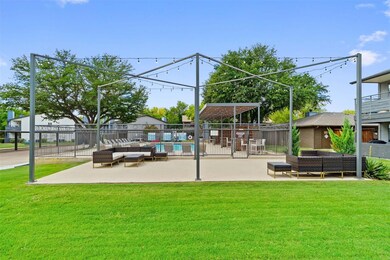 View of community featuring a yard, outdoor lounge