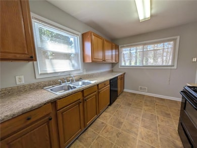 Kitchen featuring visible vents, baseboards, light