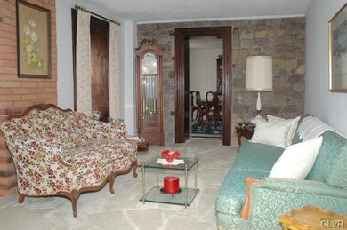 Living room with exposed stone wall