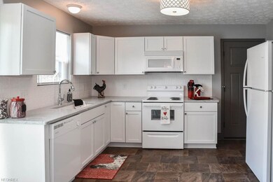 Fully applianced kitchen with white, soft-close ca