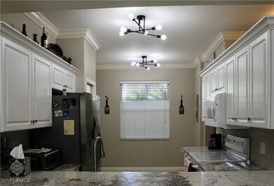 Kitchen with crown molding, a chandelier, and whit