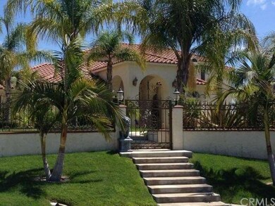 Front view of home with wrought iron gates 