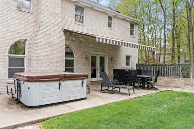Private rear patio with hot tub and awning.