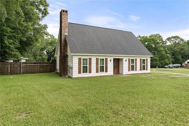 View of front of house with a chimney and roof with shingles