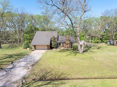 View of front facade with a front lawn, driveway, 