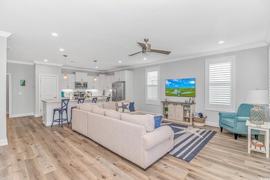 Living area featuring baseboards, ceiling fan, cro