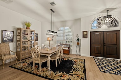 Dining area featuring a chandelier and light wood-type flooring