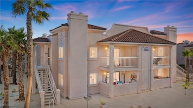 Front of property at dusk with a balcony, a tile r