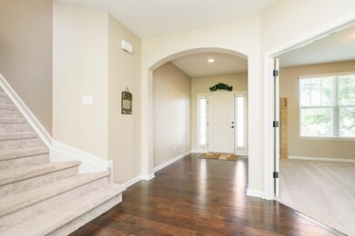 Looking towards foyer, den/library, and staircase to upstairs
