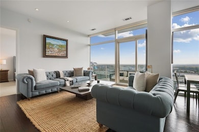 Living area featuring floor to ceiling windows and hardwood / wood-style floors