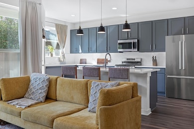 Kitchen with stainless steel appliances, open flo