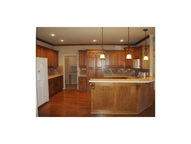 Kitchen with view into walk-in pantry & laundry ro