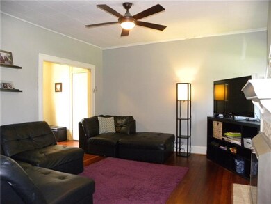 Another view of the living area with ceiling fan s