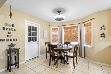Tiled dining area featuring a textured ceiling