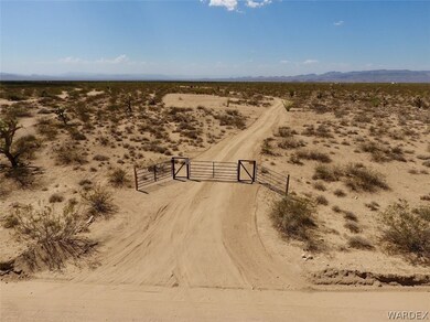 Gate with road and partial cleared area.