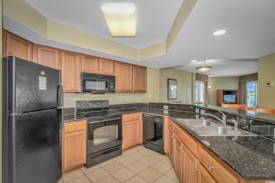 Kitchen featuring brown cabinetry, a sink, and bla