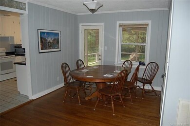 Dining room features painted paneling, crown moldi