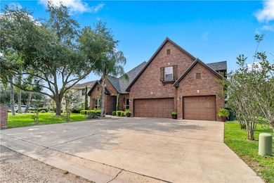Traditional-style home with concrete driveway, a shingled roof, a front yard, an attached garage, and brick siding
