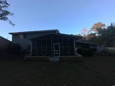 Back of property with a sunroom