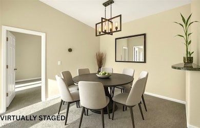 Dining space featuring baseboards, lofted ceiling,