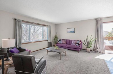 Main level open concept living room that extends to the dining room, kitchen, and sunbathed deck