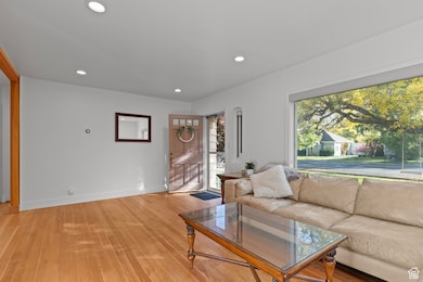 Living room with recessed lighting and light wood finished floors