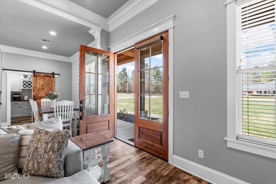 Entryway featuring ornamental molding, a barn door