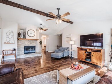 Vaulted Great Room with beam, fireplace and hickor