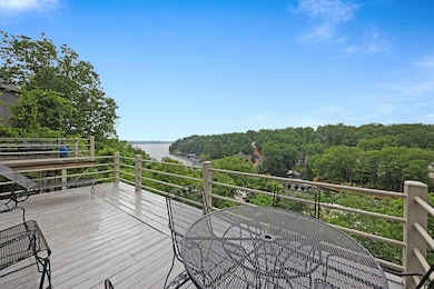 Wooden terrace featuring a water view and outdoor 